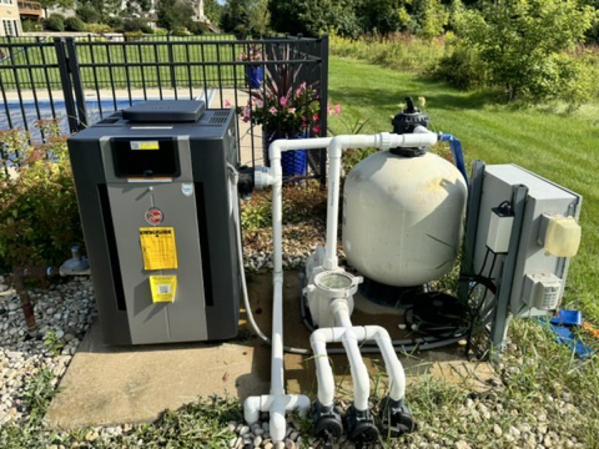Complete pool equipment pad with sand filter, heater, and pump maintained by Heartland Pool and Spa