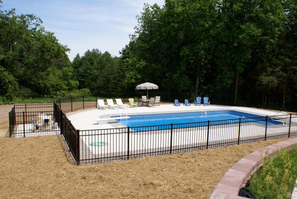 Fenced in-ground pool in Waukesha County WI opened and swim-ready by Heartland Pool and Spa